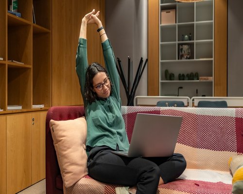 Woman doing light stretching at office